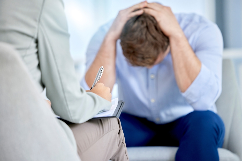 Anxious male patient consulting his therapist